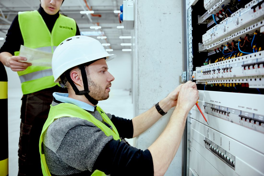 Rhino engineers commissioning utility monitoring at a building electrical panel